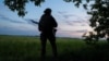 A Ukrainian serviceman guards an area near the town of Vovchansk