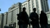 Russian policemen walk past the building of the Russian State Duma (lower house of the Parliament) in central Moscow on September 24, 2024.